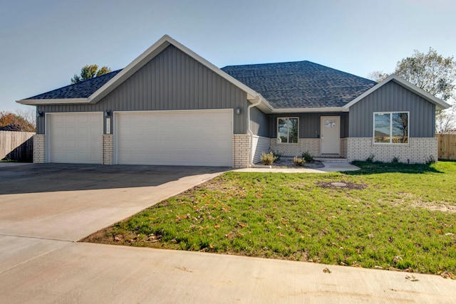 view of front of property featuring a front lawn and a garage