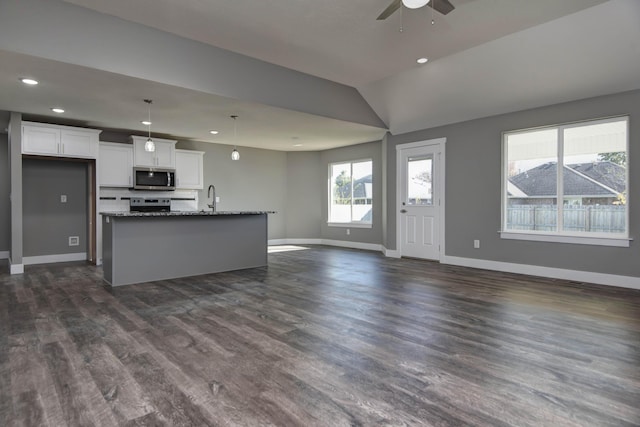 3668 W Overland St, Springfield, MO 65807 - kitchen with appliances with stainless steel finishes, open floor plan, a sink, white cabinets, and ceiling fan
