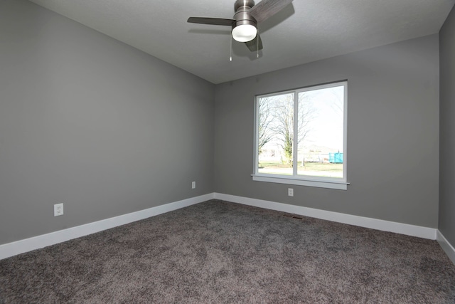 carpeted spare room featuring ceiling fan