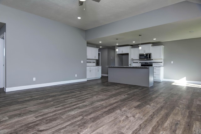 3668 W Overland St, Springfield, MO 65807 - kitchen featuring stainless steel appliances, baseboards, dark wood-style floors, white cabinetry, and recessed lighting
