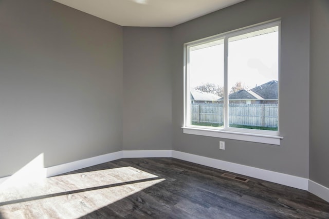 3668 W Overland St, Springfield, MO 65807 - empty room featuring plenty of natural light, baseboards, and dark wood-style floors