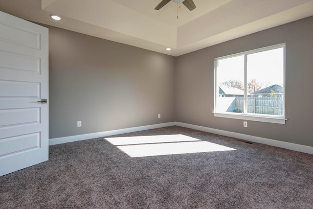 empty room featuring dark colored carpet and ceiling fan