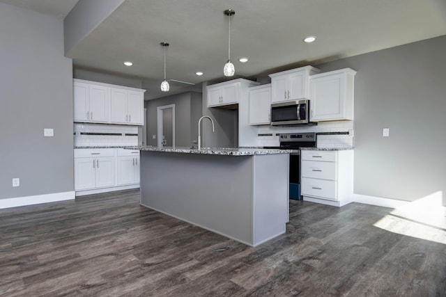 3668 W Overland St, Springfield, MO 65807 - kitchen featuring stainless steel appliances, decorative backsplash, dark wood finished floors, and recessed lighting