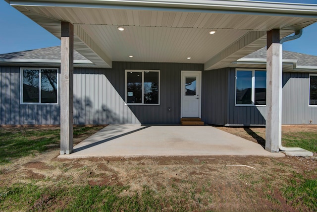 doorway to property featuring a lawn and a patio area