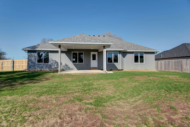 rear view of property with a patio and a yard