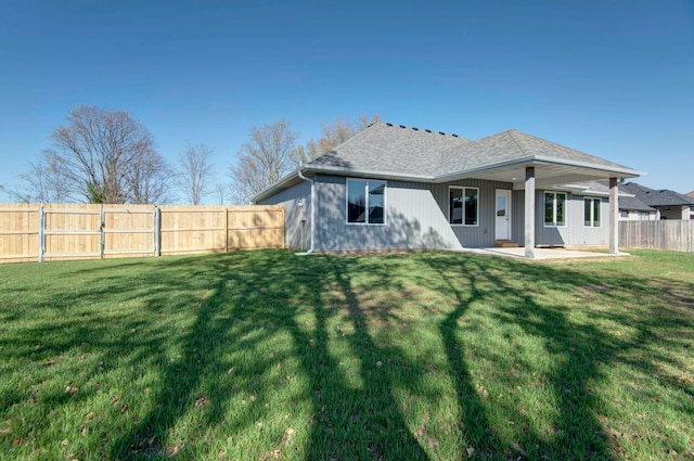 back of property with a patio and a yard