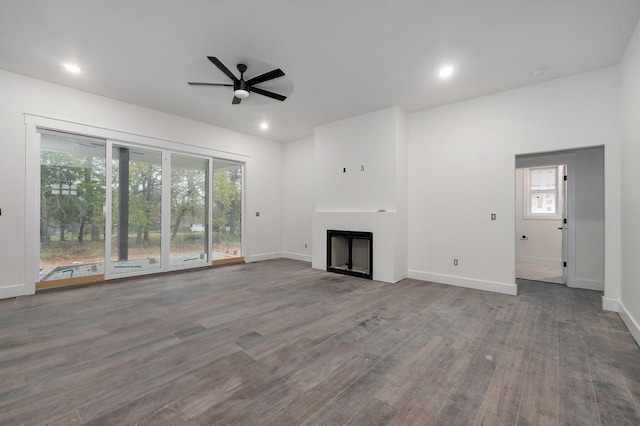 unfurnished living room featuring hardwood / wood-style flooring and ceiling fan