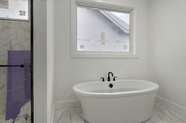 bathroom with a tub to relax in