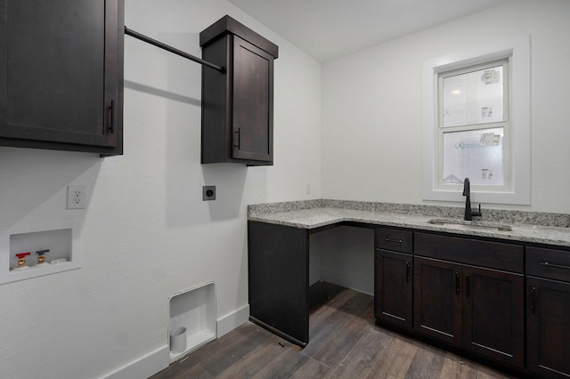 clothes washing area with cabinets, hookup for a washing machine, dark hardwood / wood-style flooring, hookup for an electric dryer, and sink