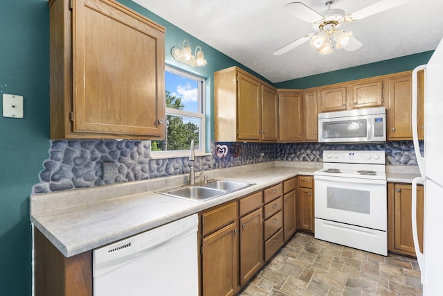 kitchen featuring decorative backsplash, white appliances, sink, and ceiling fan