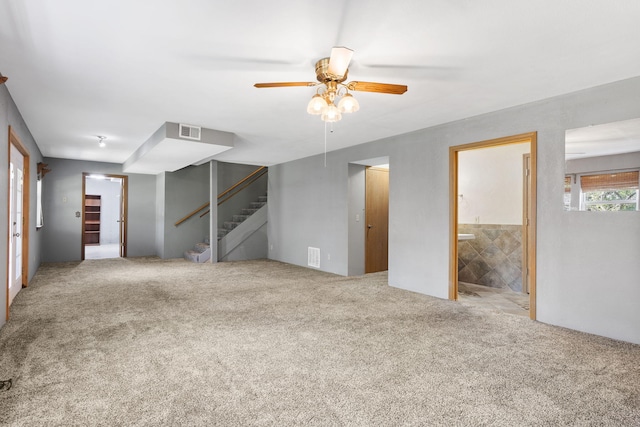 basement with light carpet and ceiling fan