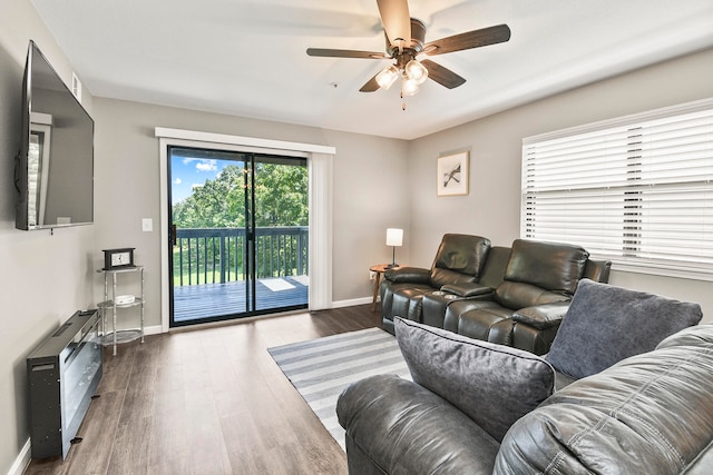 living room with dark hardwood / wood-style floors and ceiling fan