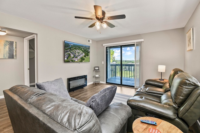 living room featuring hardwood / wood-style flooring and ceiling fan