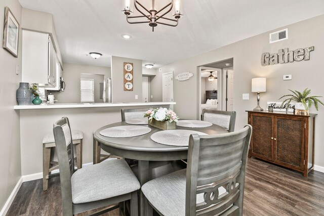 dining room featuring an inviting chandelier and dark hardwood / wood-style flooring