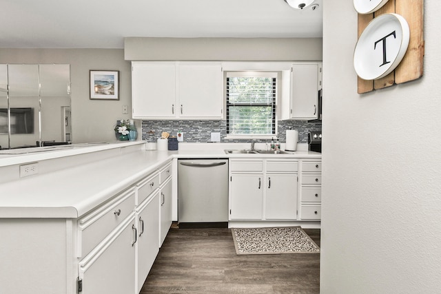 kitchen featuring kitchen peninsula, sink, white cabinetry, dishwasher, and dark hardwood / wood-style floors