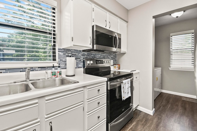 kitchen with sink, tasteful backsplash, white cabinetry, stainless steel appliances, and dark hardwood / wood-style flooring