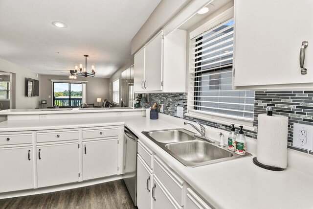 kitchen featuring decorative light fixtures, decorative backsplash, dark hardwood / wood-style floors, white cabinets, and stainless steel dishwasher