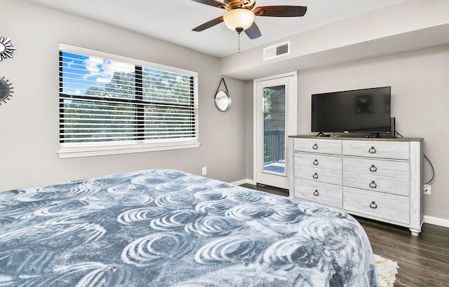 bedroom featuring access to outside, dark hardwood / wood-style floors, and ceiling fan