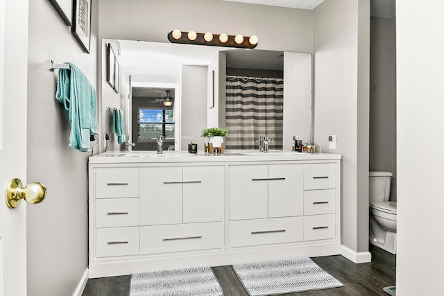 bathroom featuring hardwood / wood-style floors, vanity, and toilet