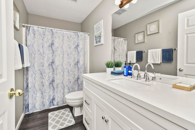 bathroom featuring a shower with shower curtain, vanity, toilet, and hardwood / wood-style flooring