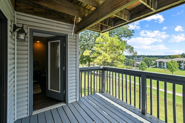 wooden deck featuring a lawn