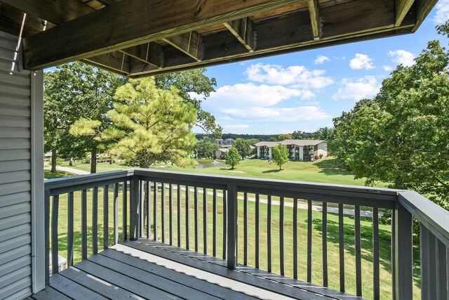 wooden deck with a lawn