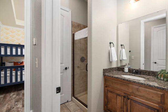 bathroom with an enclosed shower, hardwood / wood-style flooring, and vanity