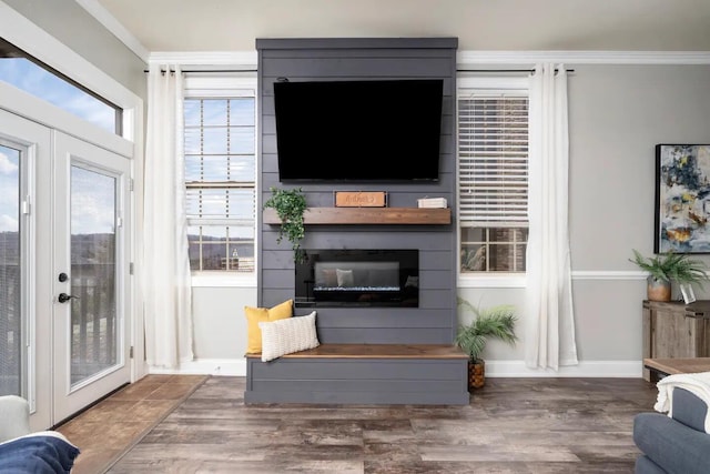 living room featuring ornamental molding, a fireplace, french doors, and dark hardwood / wood-style floors