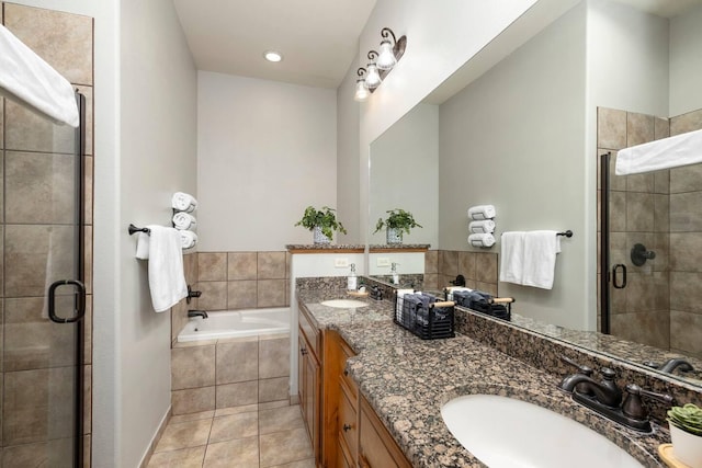 bathroom featuring tile patterned flooring, vanity, and plus walk in shower