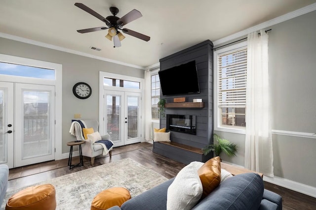 living room with french doors, ceiling fan, dark wood-type flooring, and a wealth of natural light