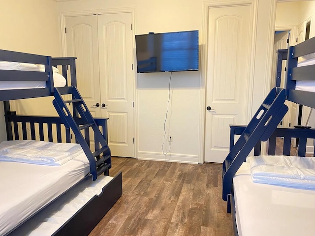 bedroom with a closet and dark hardwood / wood-style floors