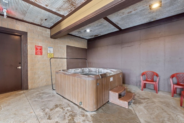 miscellaneous room featuring a jacuzzi and beamed ceiling