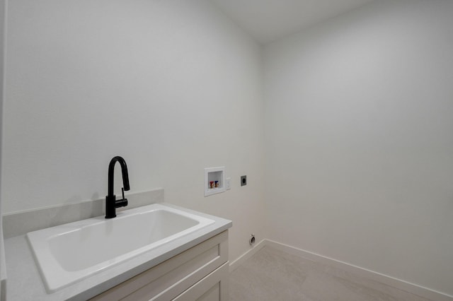 laundry room featuring hookup for a washing machine, hookup for an electric dryer, sink, light tile patterned flooring, and cabinets