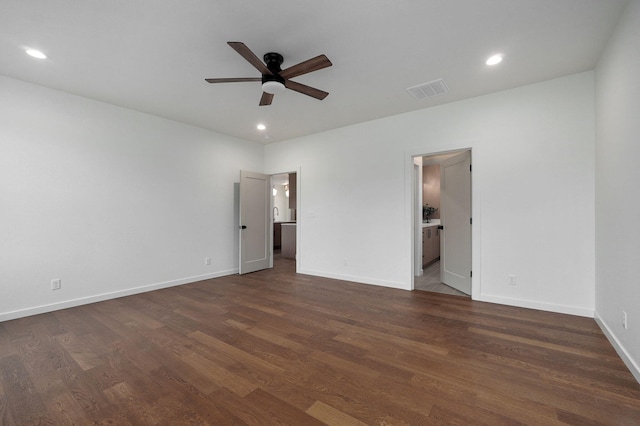 unfurnished bedroom featuring ceiling fan, connected bathroom, and dark hardwood / wood-style flooring