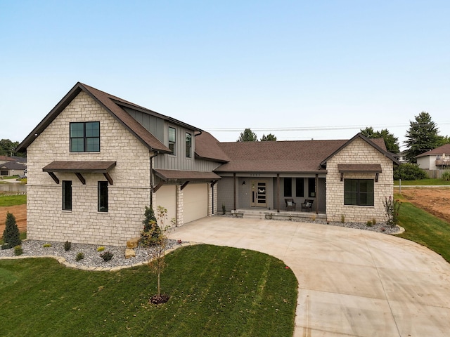 view of front of home featuring a front yard and a garage