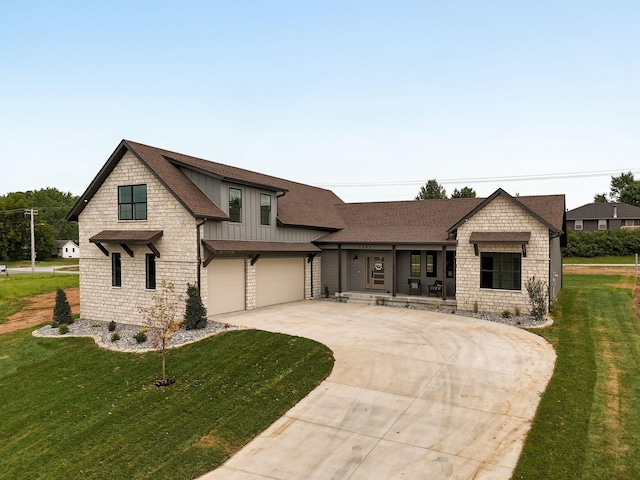 view of front of property featuring a garage and a front lawn