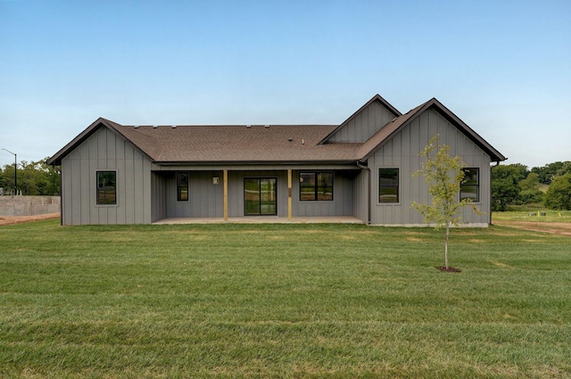 rear view of property with a yard and a patio