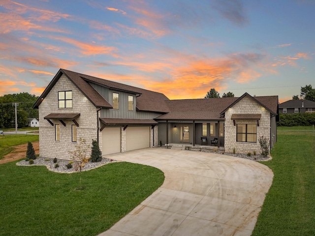 view of front of property with a garage and a lawn