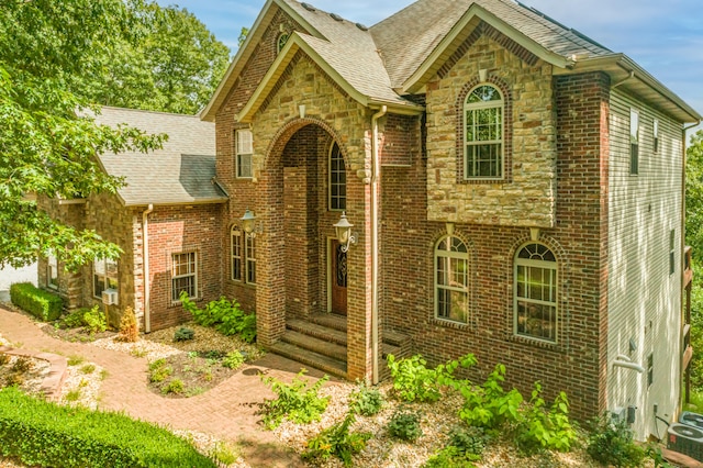 tudor house featuring central air condition unit