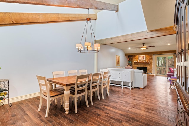 dining room featuring a fireplace, ceiling fan with notable chandelier, hardwood / wood-style floors, and lofted ceiling with beams