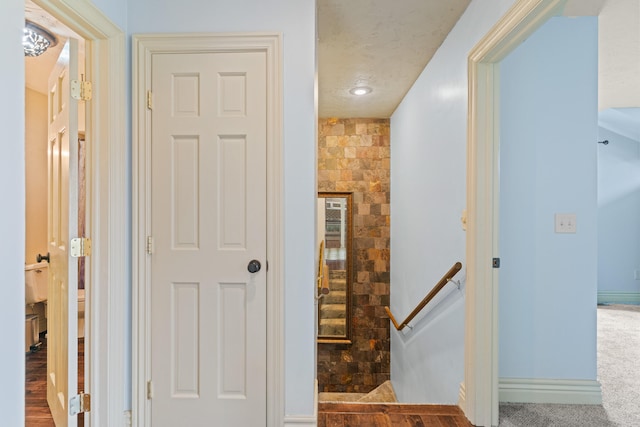 corridor with hardwood / wood-style flooring