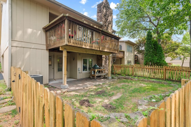 back of house with a wooden deck, central AC unit, and a patio area