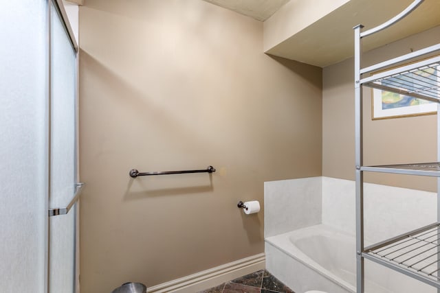 bathroom featuring a washtub and tile patterned floors