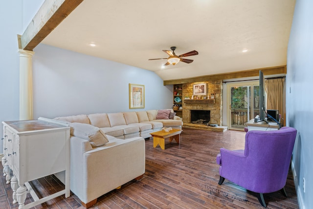 living room featuring ceiling fan, a stone fireplace, dark wood-type flooring, ornate columns, and vaulted ceiling with beams