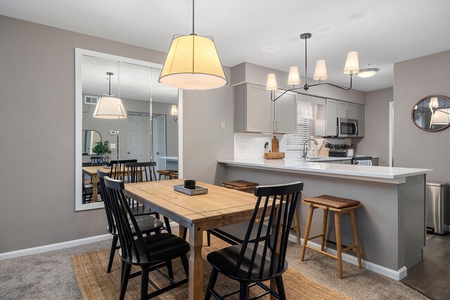 carpeted dining room featuring sink