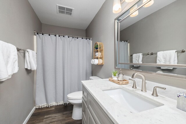 bathroom featuring hardwood / wood-style flooring, vanity, and toilet