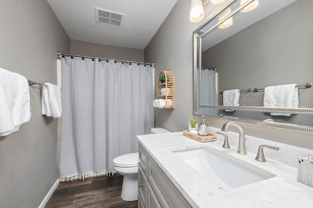 132 Highland Dr Unit 8, Branson, MO 65616 - bathroom featuring wood finished floors, vanity, baseboards, toilet, and visible vents
