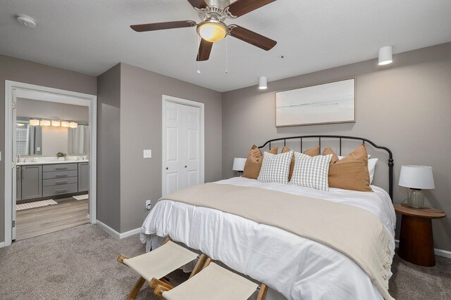 carpeted bedroom with ceiling fan, a closet, and connected bathroom