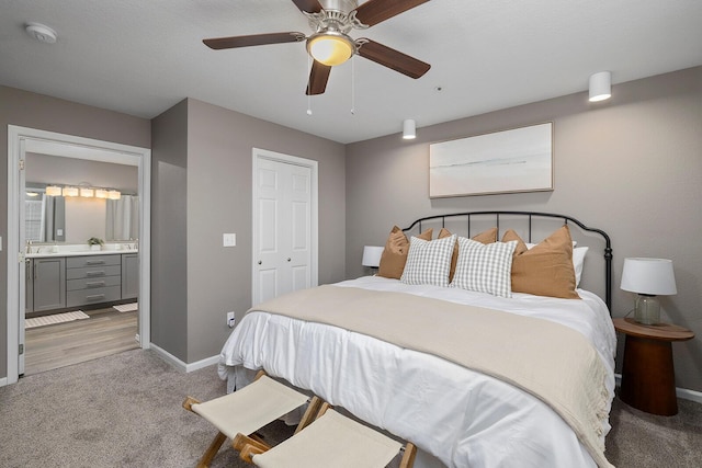 132 Highland Dr Unit 8, Branson, MO 65616 - bedroom featuring a ceiling fan, a closet, ensuite bath, baseboards, and light colored carpet