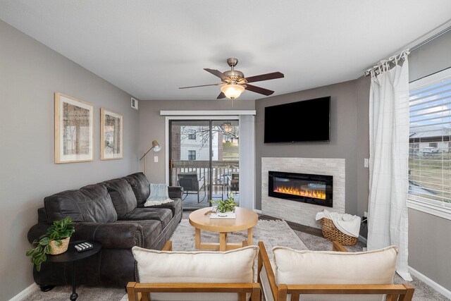 carpeted living room featuring ceiling fan